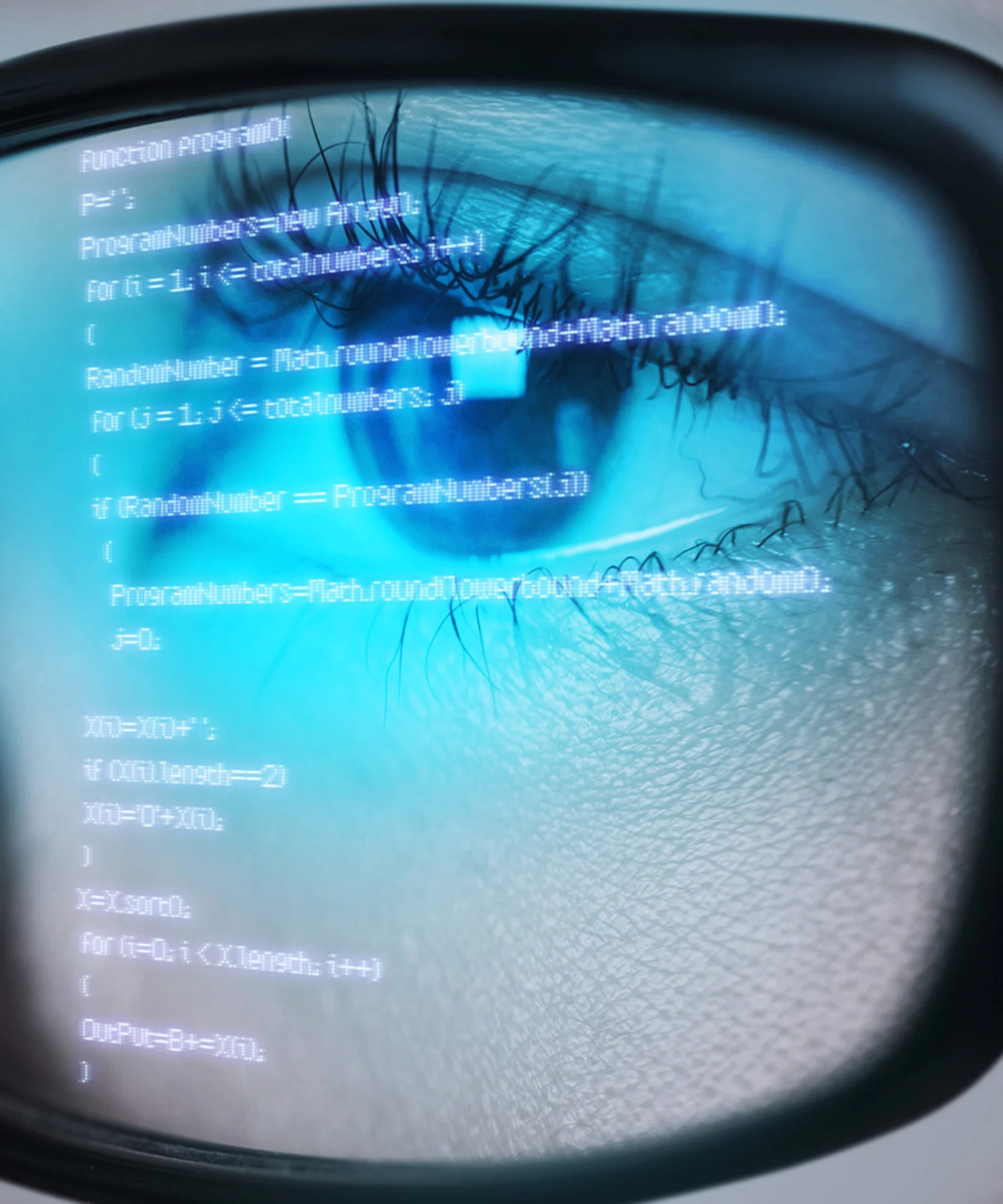 Close-up of a person&#039;s eye reflecting code on a screen, symbolizing in-depth analysis and focus in software development.