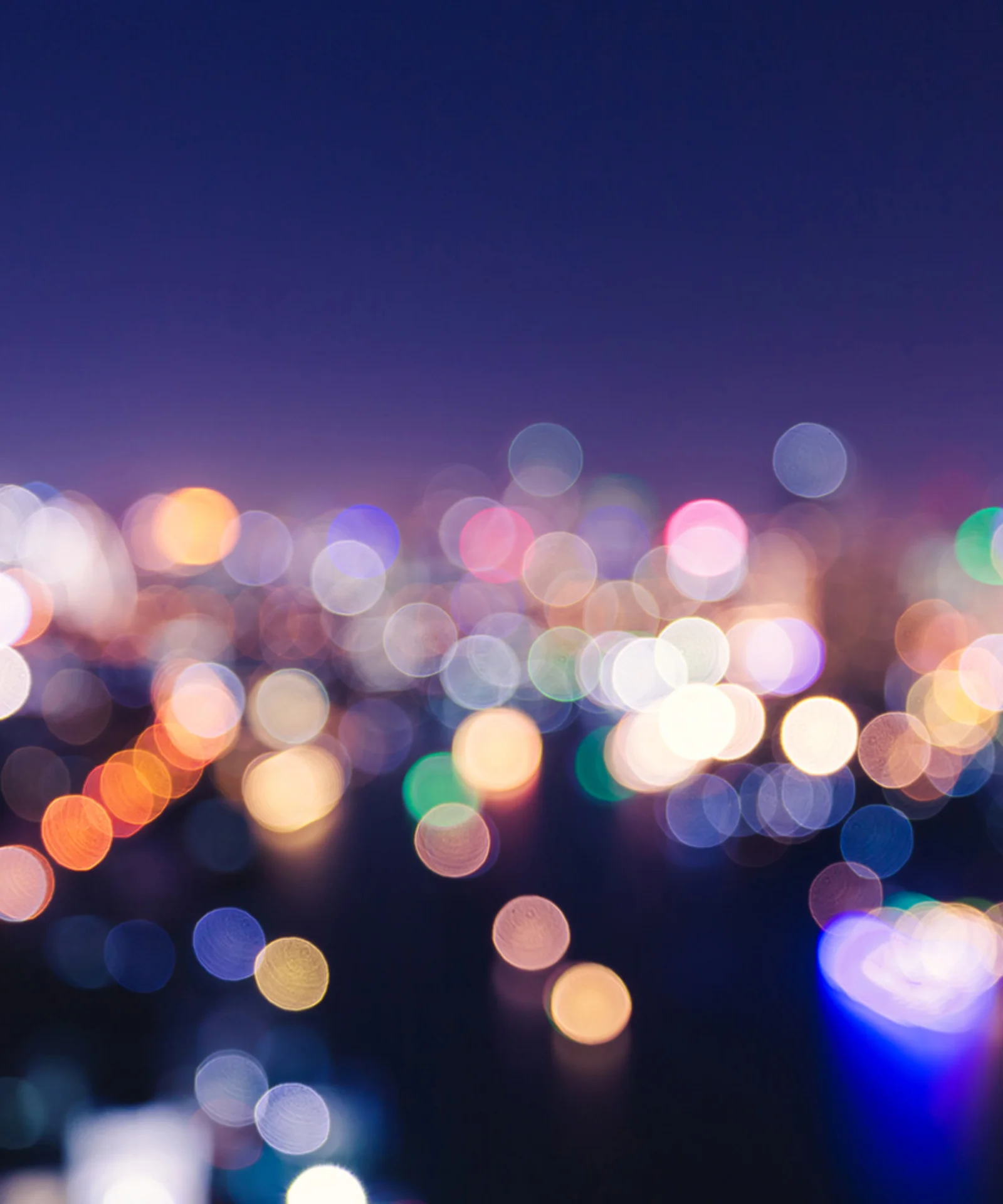 Abstract blurred city lights at night, representing opportunities and challenges.