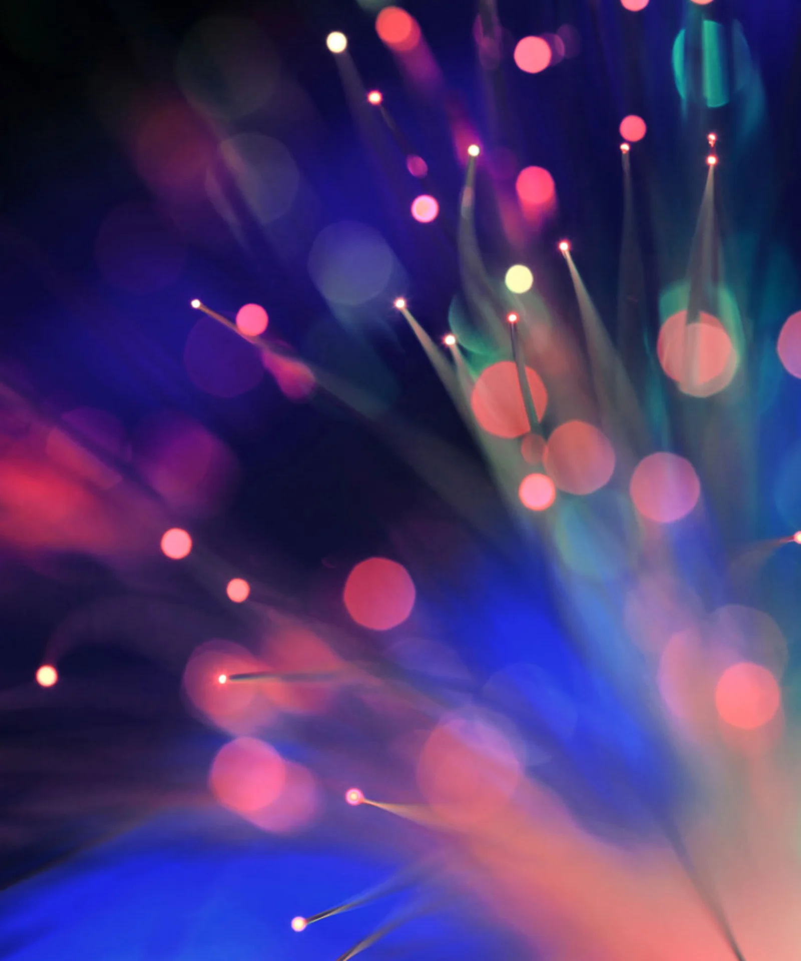 A vibrant abstract image depicting dynamic data visualisation with streaks of multicoloured lights against a dark background.