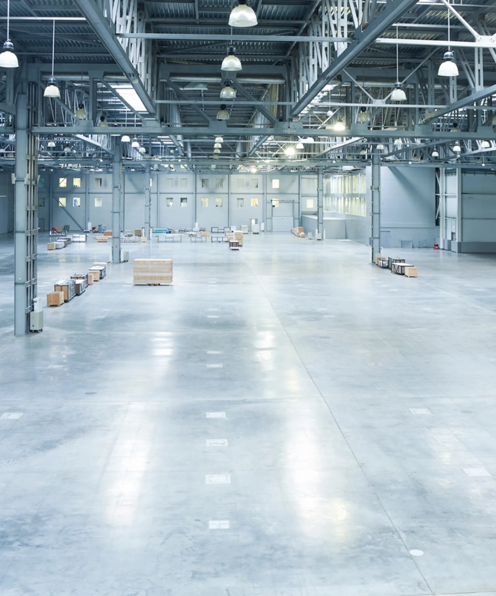 Spacious and modern warehouse interior with minimal storage and industrial lighting.