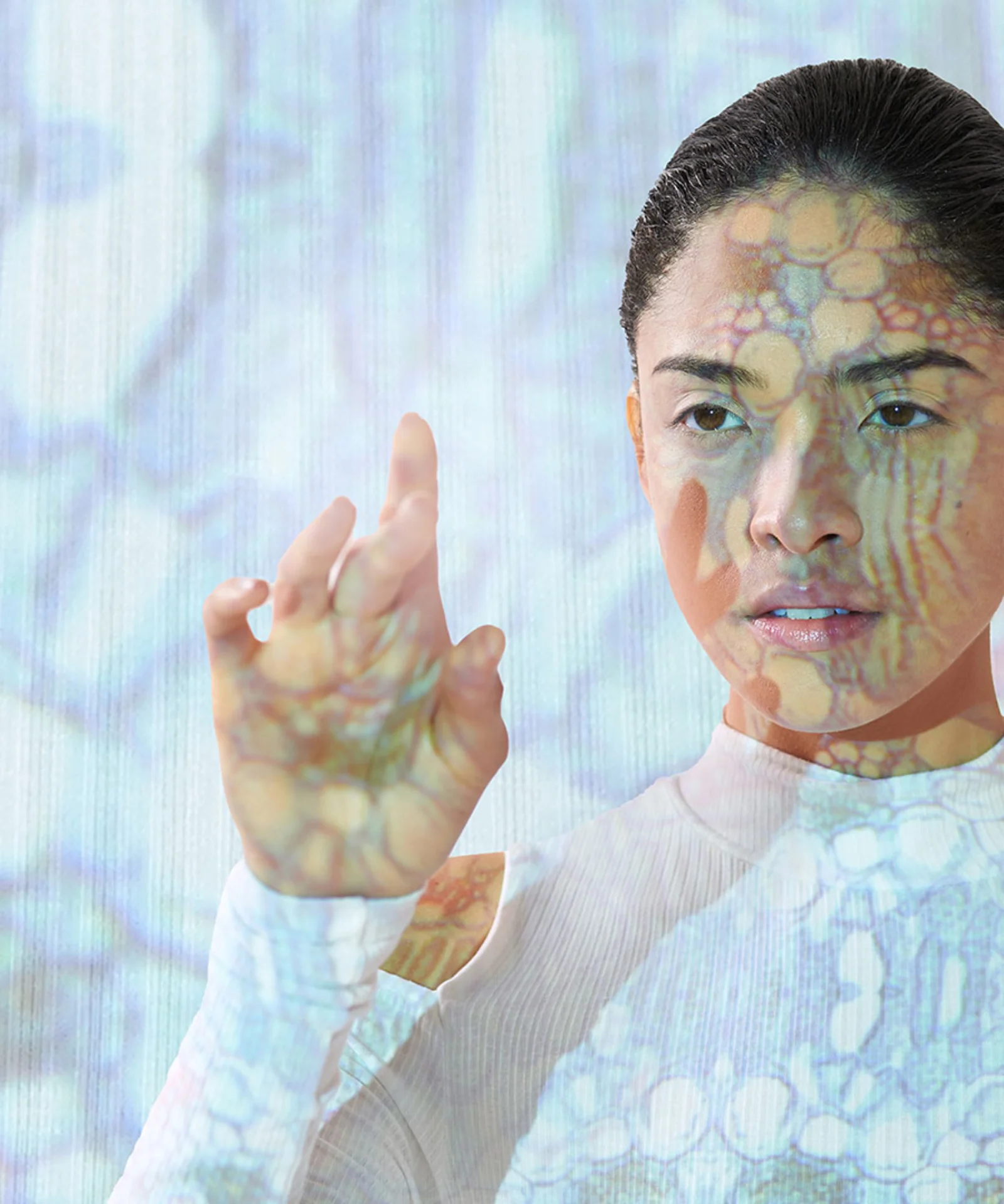 This key visual showcases a woman with digital patterns projected onto her face and body, symbolizing the integration of artificial intelligence and human interaction. The image represents the cutting-edge advancements in AI technology and its seamless blending with human capabilities.