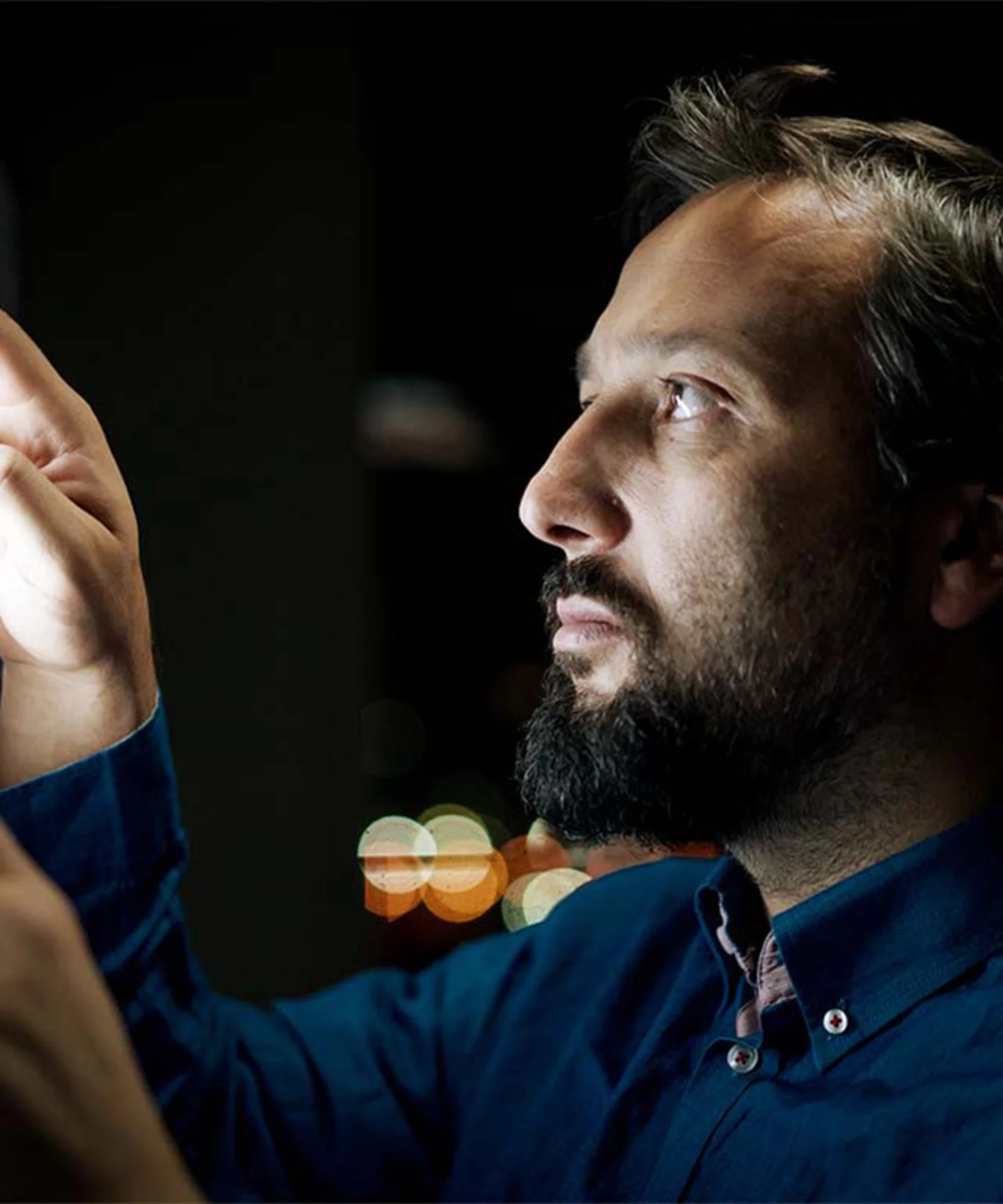 A man closely examining a digital interface, symbolising the exploration of digital transformation and Distributed Ledger Technology (DLT) in capital markets.