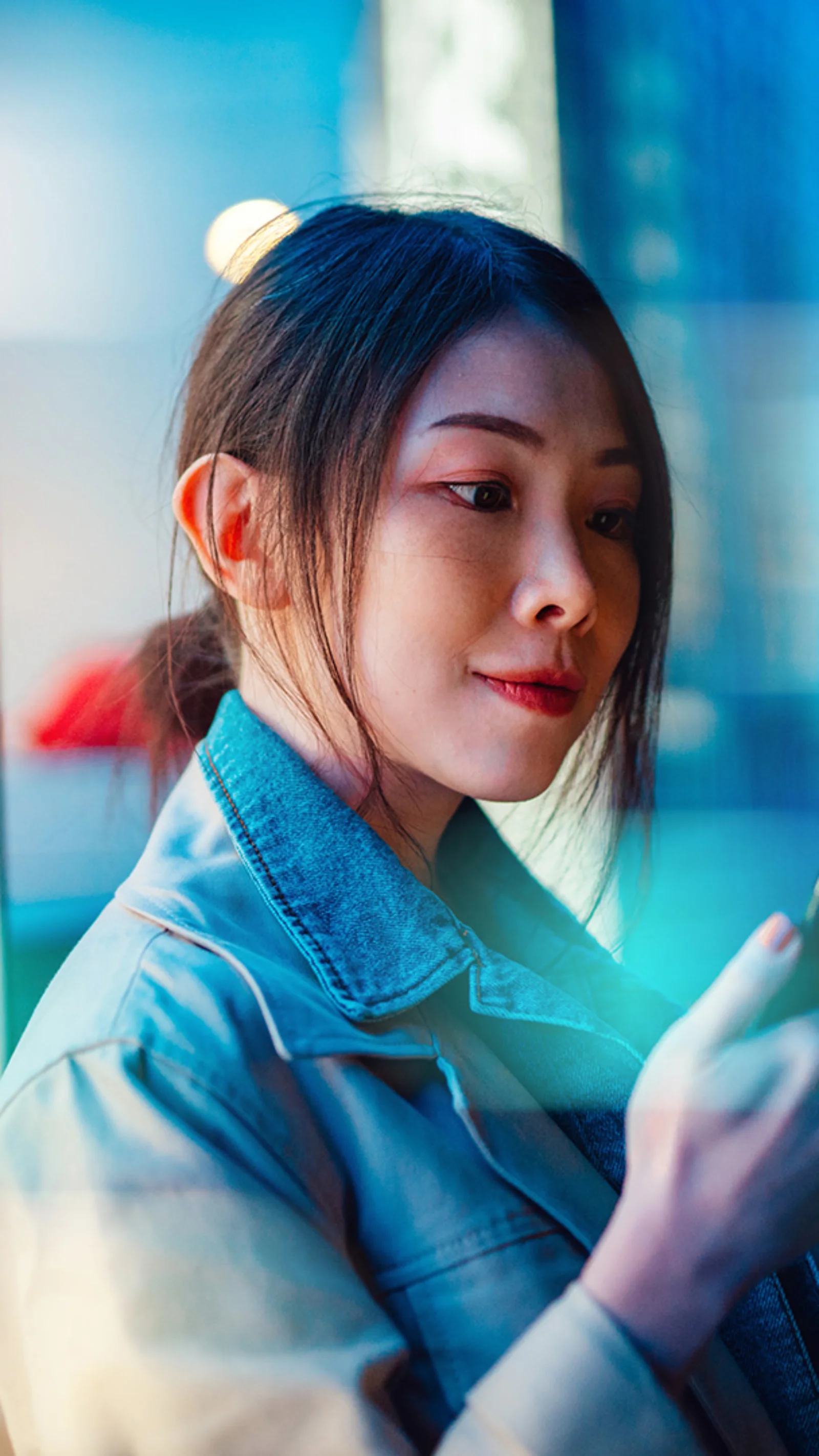 A woman using her smartphone, symbolizing the seamless integration and interoperability of digital payment systems in the regulated financial ecosystem.