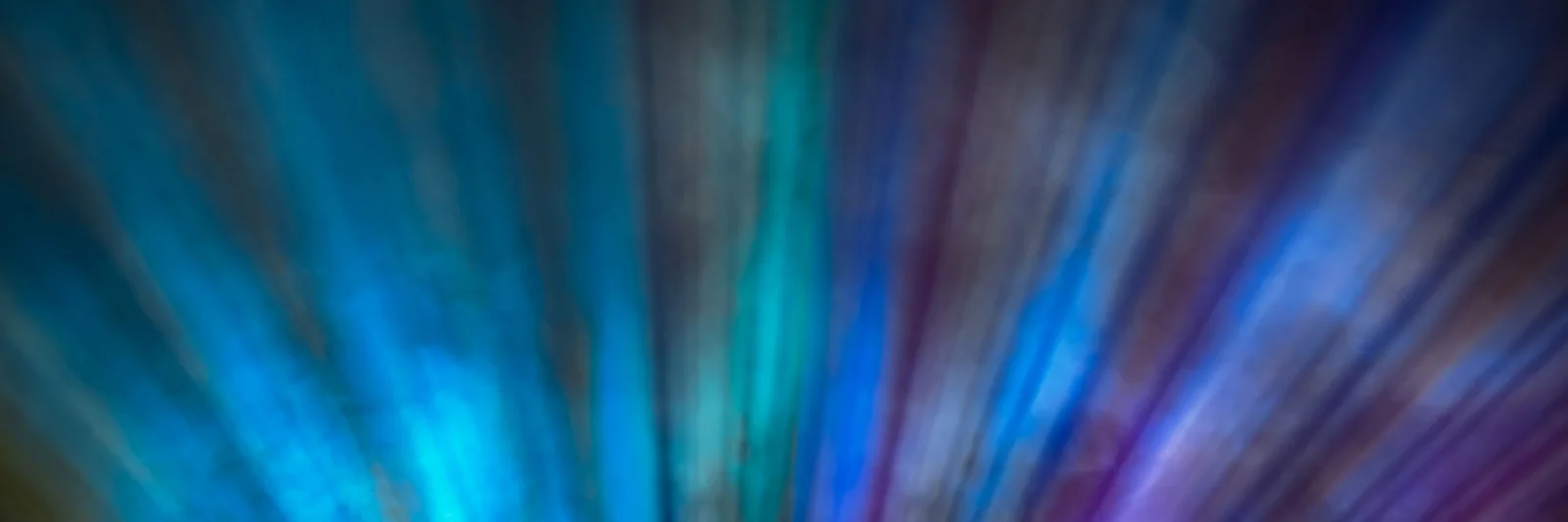 This key visual for the Smaragd Compliance Suite features an abstract composition of blue and purple light streaks, radiating outward in a dynamic and vibrant display. The colors and motion convey a sense of innovation, technology, and complexity, reflecting the advanced capabilities of the Smaragd Compliance Suite in managing and ensuring regulatory compliance. The visual effect evokes a futuristic and high-tech atmosphere, aligning with the suite&#039;s cutting-edge solutions for financial institutions.