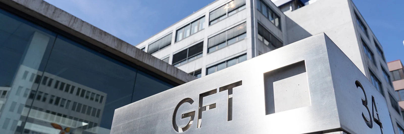 A view of the exterior of GFT&#039;s headquarters building, featuring the company&#039;s logo and modern architectural design.