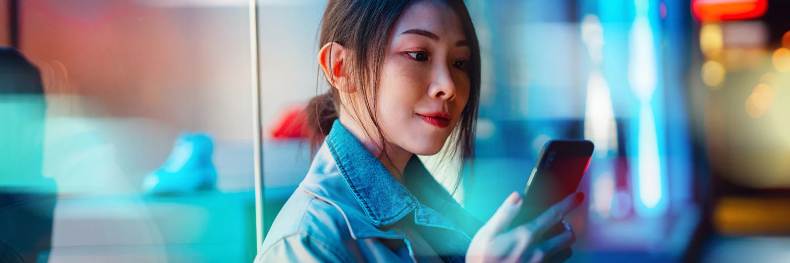 A woman using her smartphone, symbolizing the seamless integration and interoperability of digital payment systems in the regulated financial ecosystem.