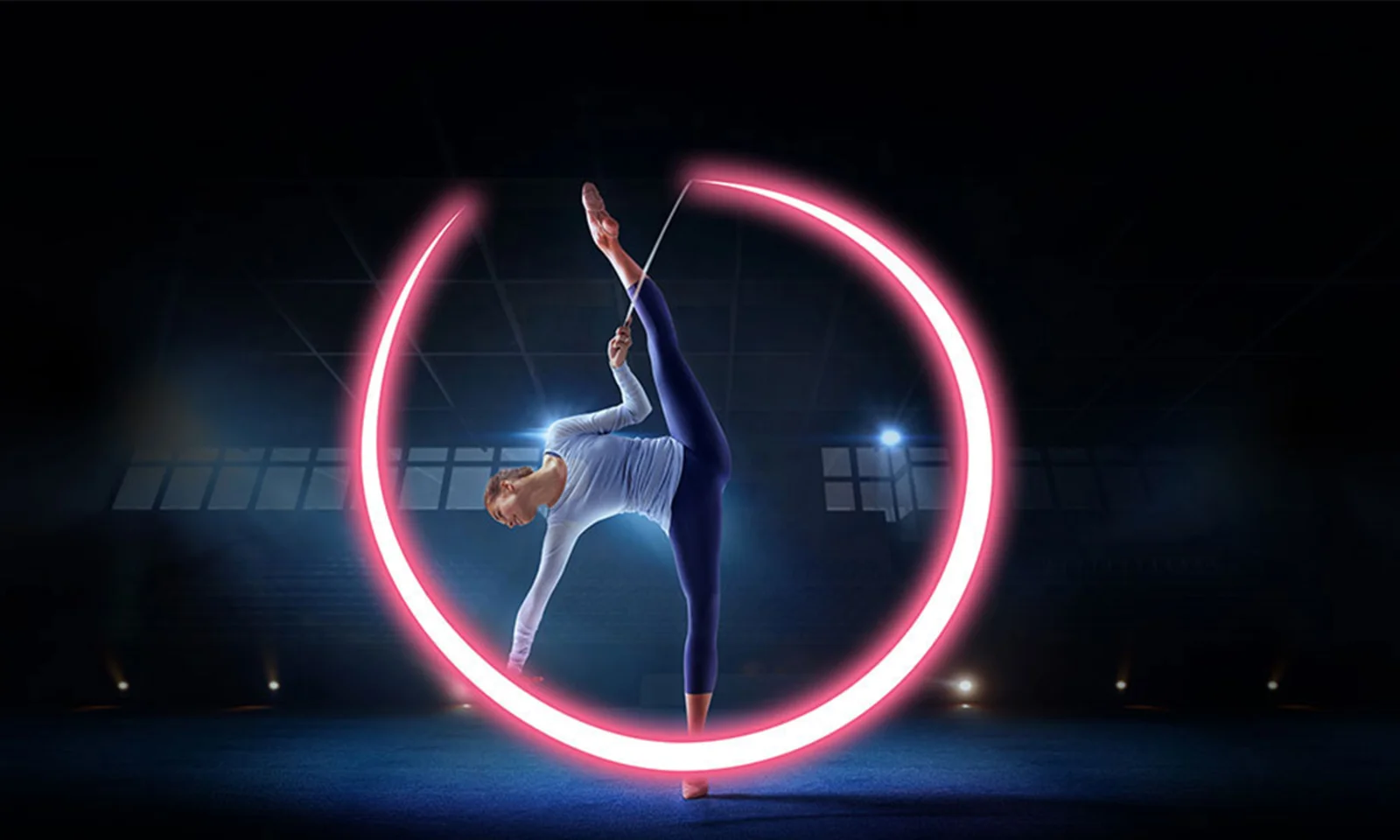 Gymnast performing a balance pose with a glowing pink circular light.