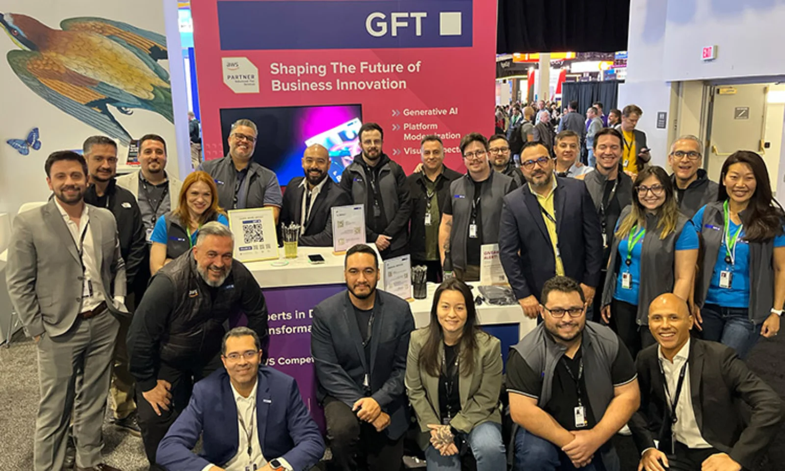 The GFT team posing in front of their booth at a technology event, featuring a banner highlighting services like Generative AI, Platform Modernization, and Visual Inspection.