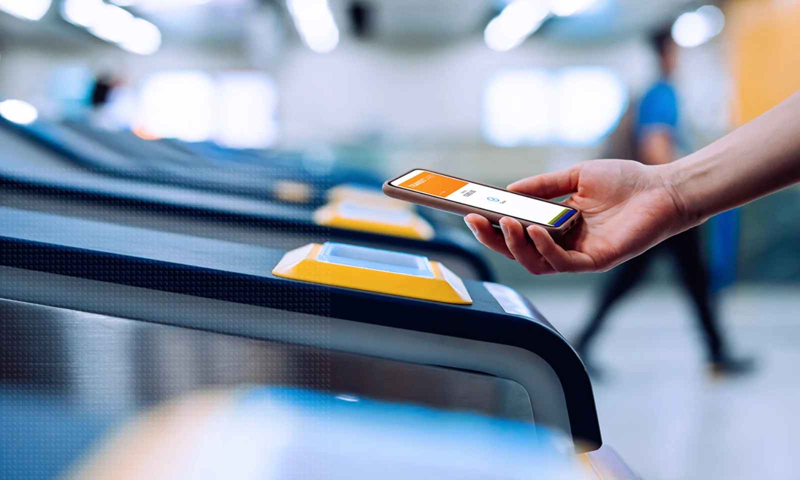 A person uses a smartphone with a digital ticketing app to access a public transit gate, showcasing the use of mobile technology in transportation systems.