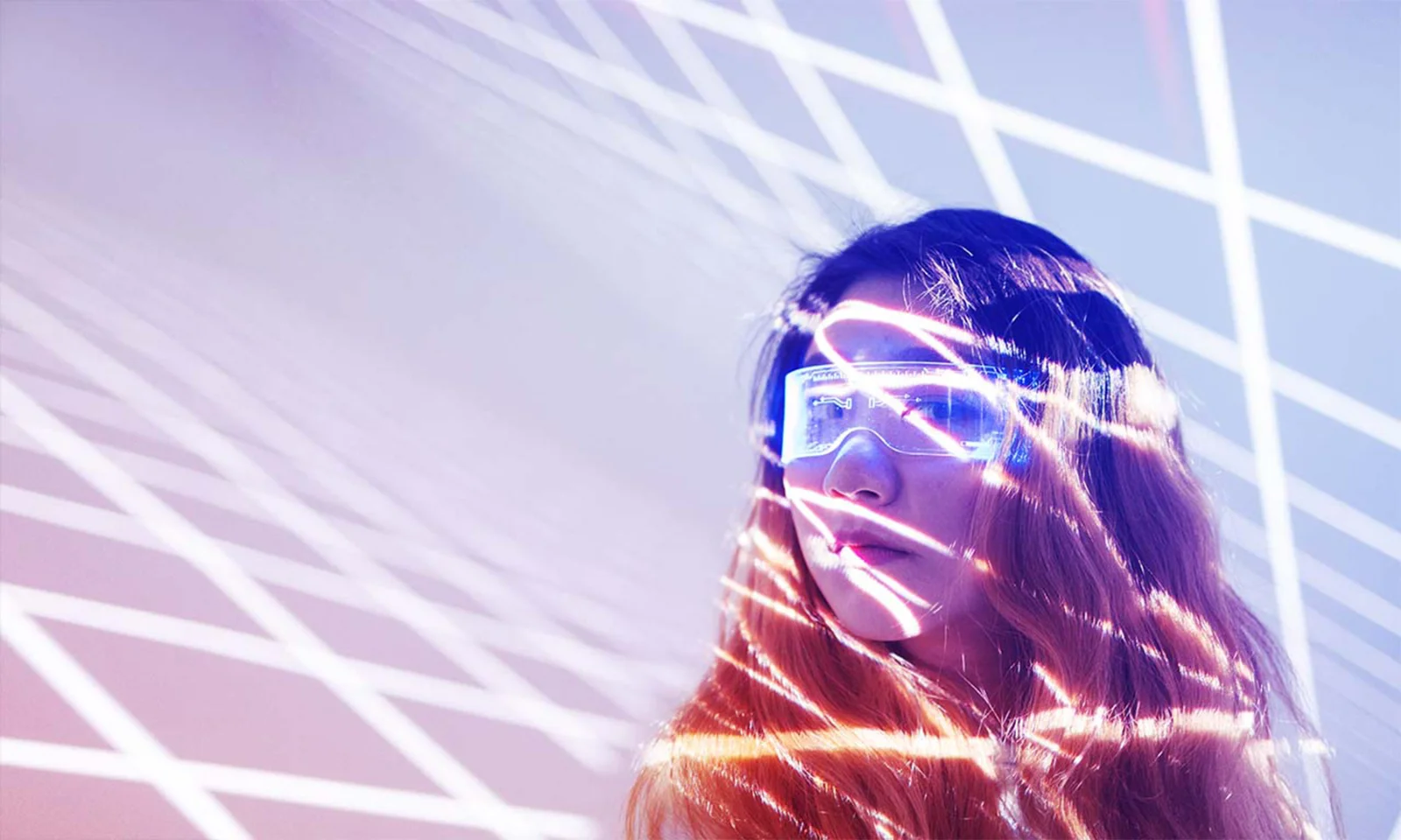 This image captures the essence of innovation with a futuristic aesthetic. A woman, adorned in high-tech glasses, is bathed in intersecting lines of light that create a dynamic and modern visual effect. The background features soft hues of purple and pink, enhancing the sense of technological advancement and forward-thinking. This visual perfectly embodies the spirit of cutting-edge innovation and the integration of technology in everyday life.