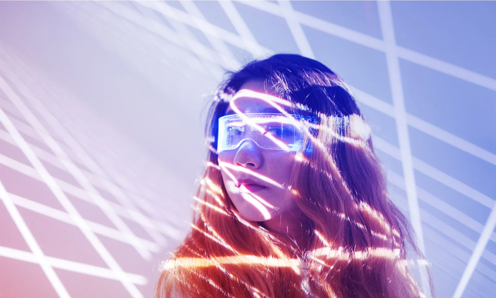Explore the future of innovation at GFT with this striking teaser image featuring a woman in futuristic glasses and dynamic light patterns. This visual symbolizes the cutting-edge advancements and forward-thinking approach at GFT&#039;s Innovation Lab.