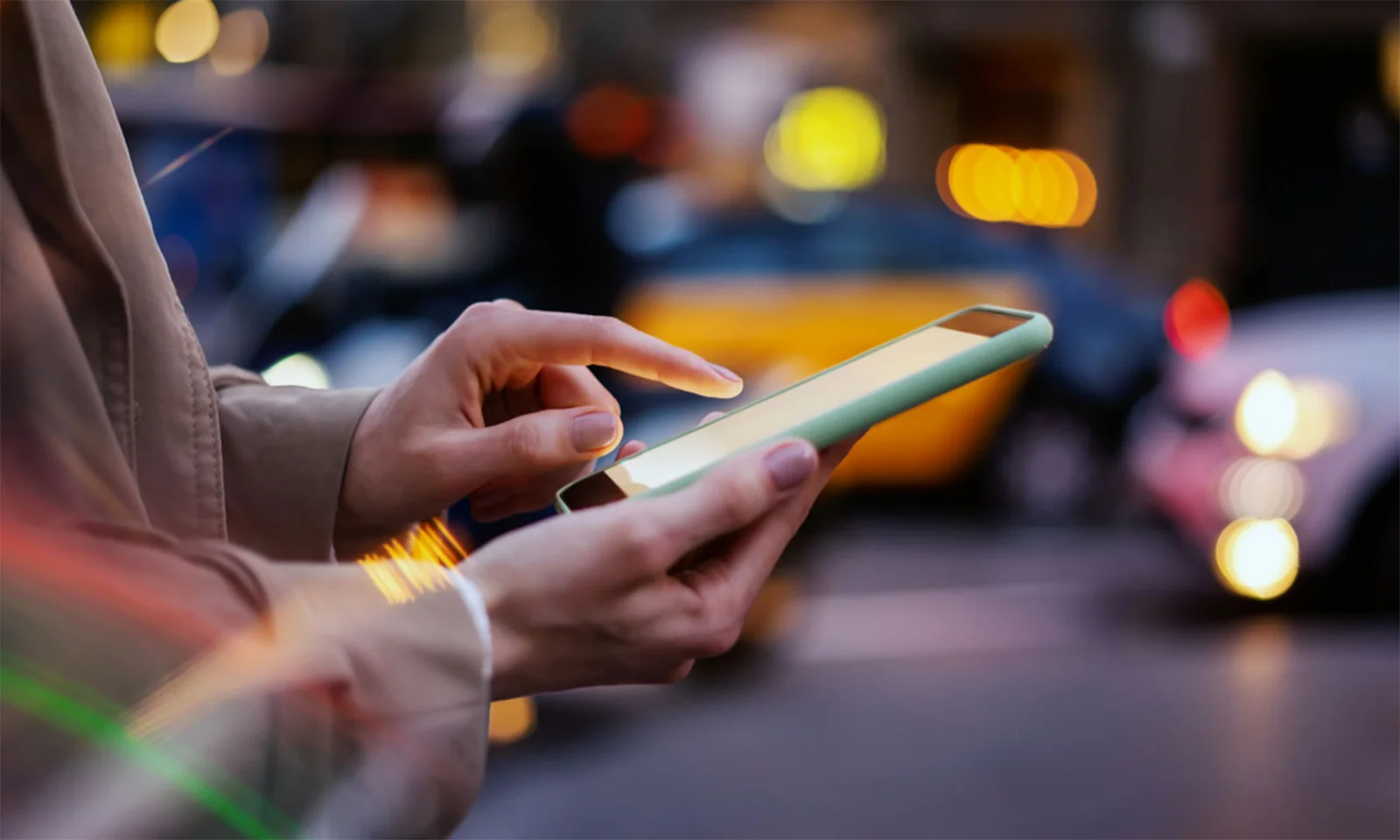 Close-up of a person using a mobile device on a busy city street, symbolising the modernisation efforts of a global bank to enhance digital banking services.