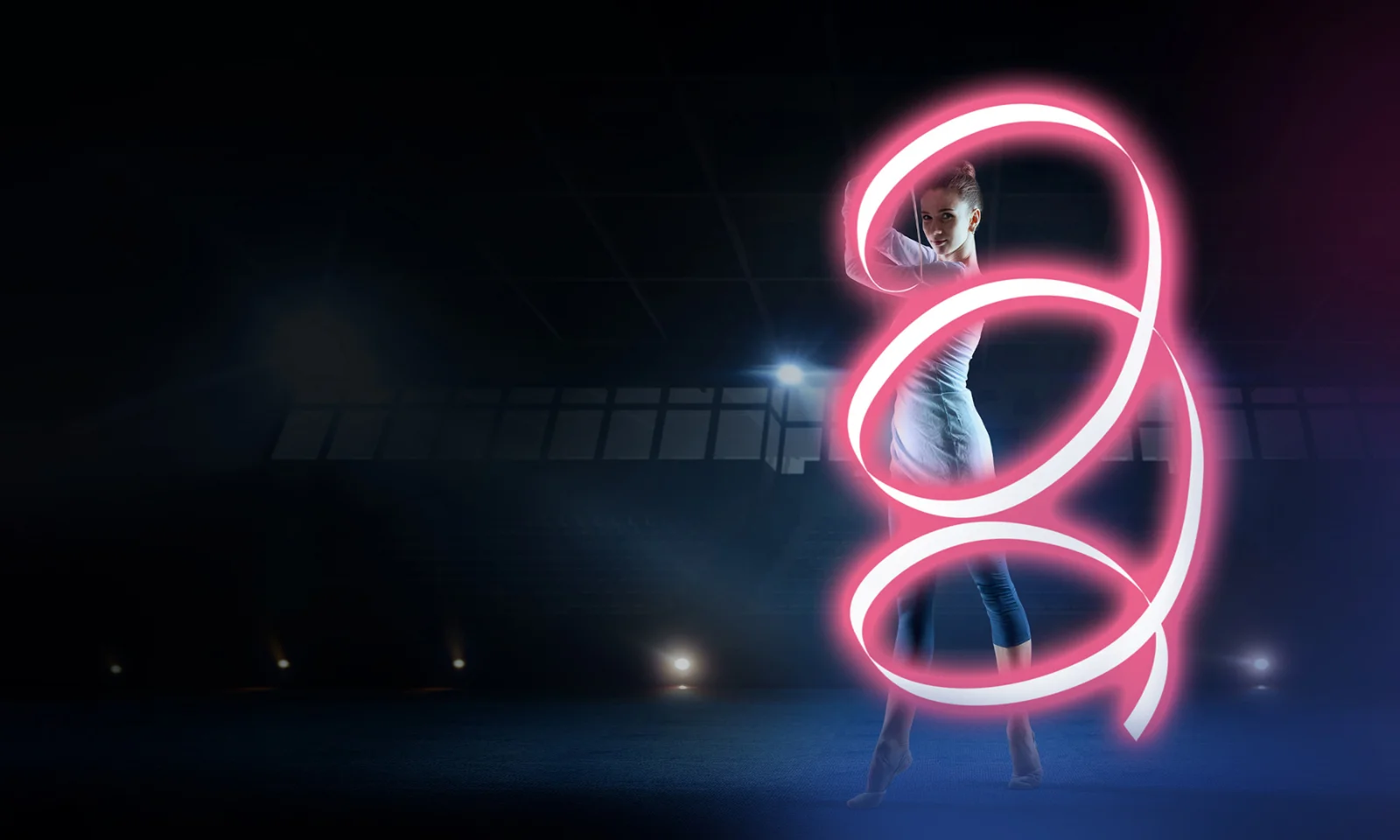 A dancer in a dark environment, illuminated by a vibrant pink light trail swirling around her, symbolising speed, precision, and agility in core banking migration.