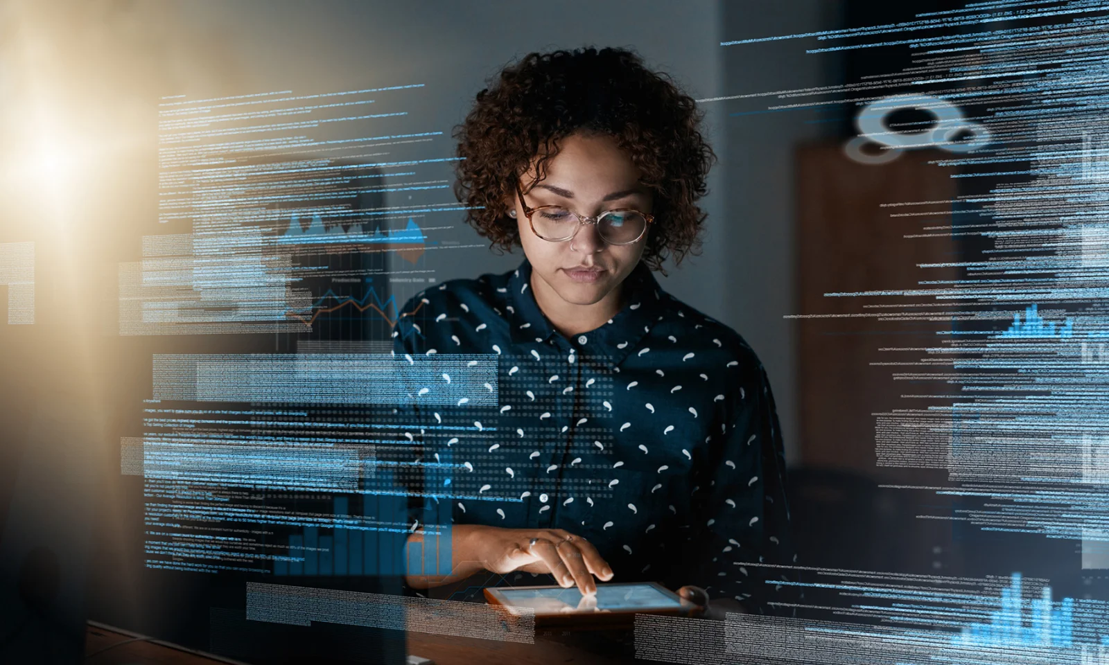 A focused professional interacts with a tablet, with digital data visuals overlaying the image, symbolizing the integration of banking services into non-banking platforms.