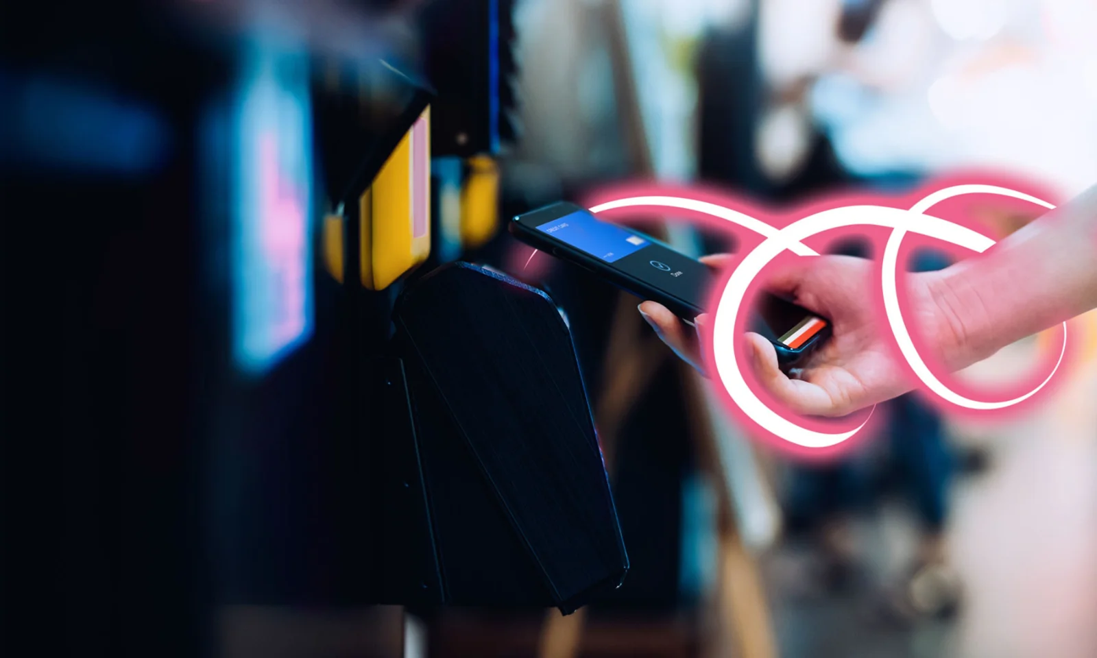 A close-up image of a hand using a mobile device to make a contactless payment, symbolised by an abstract neon loop representing connectivity and digital flow.