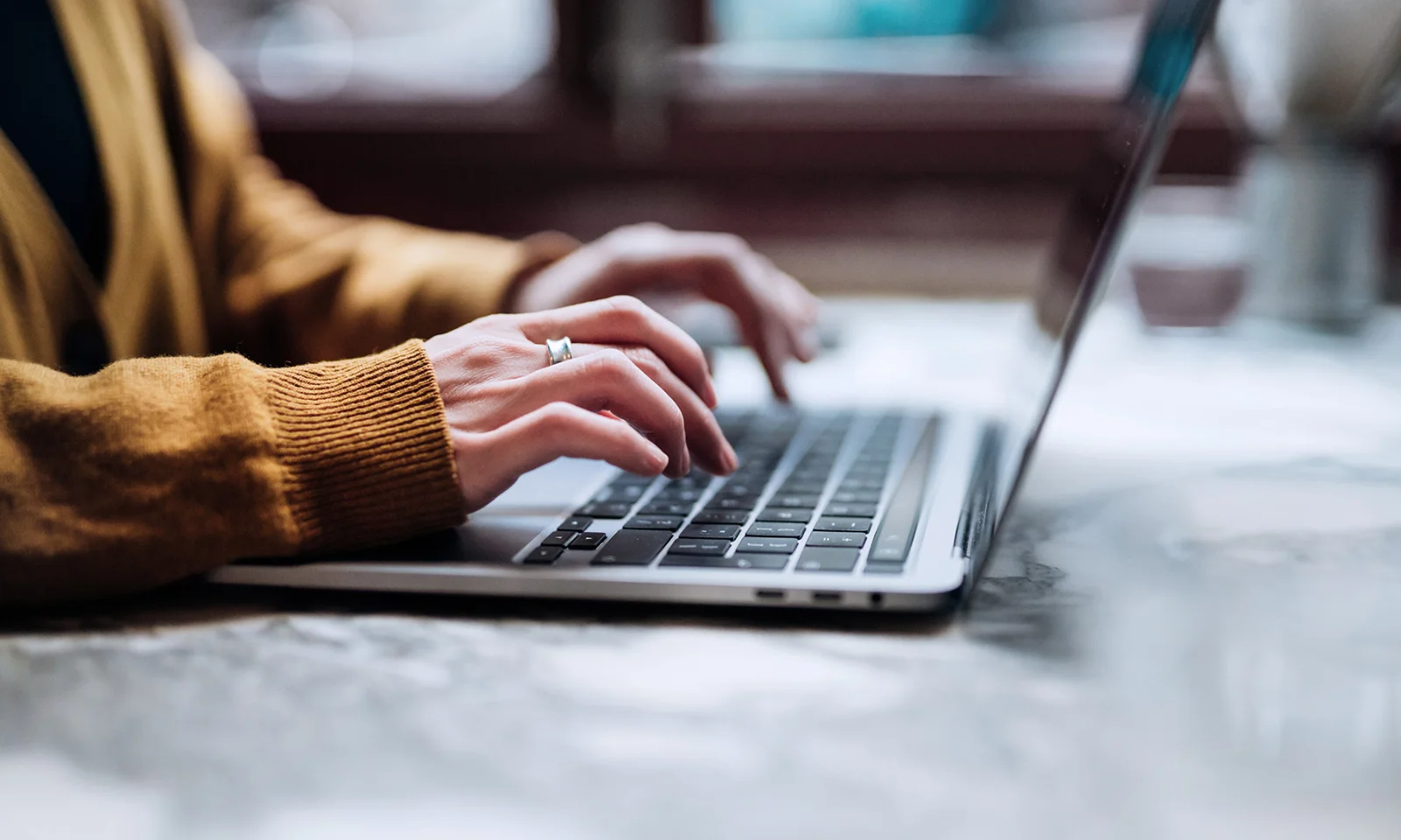 A person typing on a laptop keyboard, symbolising the engagement and interaction with ChatGPT, representing modern AI-driven communication and assistance.