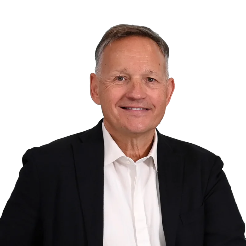 Professional headshot of Antony Jenkins, wearing a blue suit and white shirt, smiling and looking confidently into the camera.